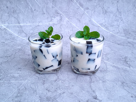 Black grass jelly with coconut milk (Es Cincau), Indonesian sweet dessert suitable for beverage in summer or breakfasting (takjil) during ramadanの写真素材