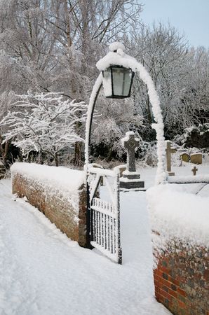 A snowy english church gatewayの写真素材