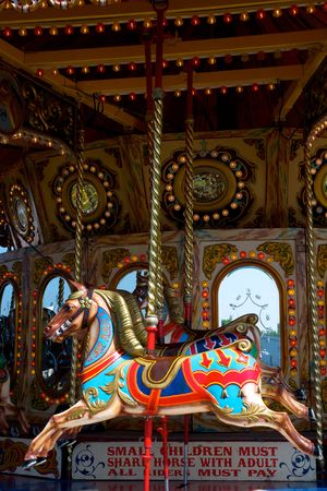 A colourful carousel, roundabout or merry go round wooden horseの写真素材