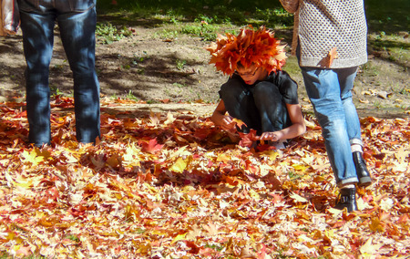 PRINCETON, NJ - October 20, 2013: Colorful autumn in one of the best and oldest universities in USA, belonging to elite Ivy Leaque, classified at the 1-st place in ranking. Girl with hat made of leaves.のeditorial素材