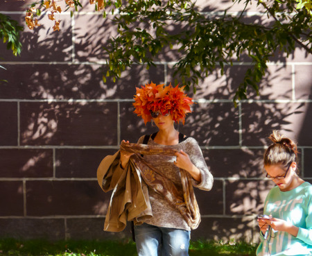 PRINCETON, NJ - October 20, 2013: Colorful autumn in one of the best and oldest universities in USA, belonging to elite Ivy Leaque, classified at the 1-st place in ranking. Girl with hat made of colorful leaves.のeditorial素材
