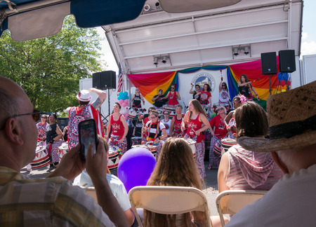 Nyack NY USA  June 14 2015: Members of Batala NYC women only band with leader on the front performing before the stage during Rockland County Pride. Observer taking pictures with the phone.のeditorial素材