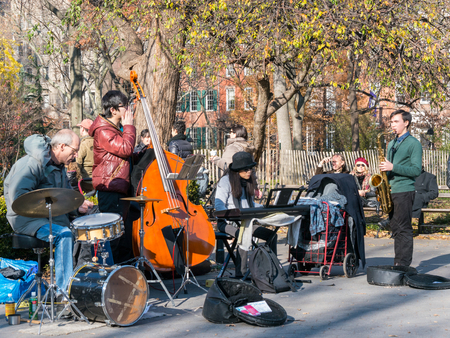 Manhattan, New York - December 06, 2015: Street musicians playing during lazy Sunday afternoon in Washington Square Park.のeditorial素材
