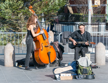Manhattan, New York - December 06, 2015: Street musicians playing during lazy Sunday afternoon in Washington Square Park.のeditorial素材