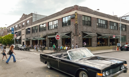 Brooklyn, New York - August 17, 2014: Vintage car and pedestrians before drink bar at Greenpointのeditorial素材