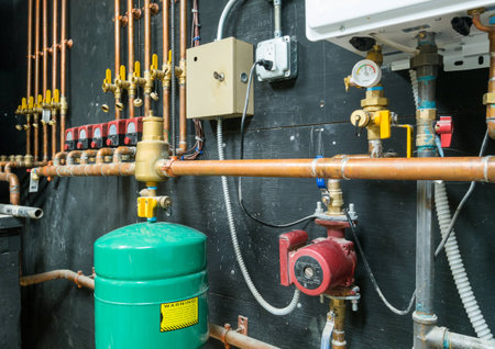 Copper pipes and valves with control unit mounted on the wallの写真素材