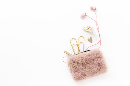 Feminine gold and pink items including stationery, earbuds, purse, heart and tapeの写真素材