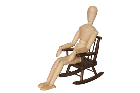  wooden dummy sitting on armchair on white backgroundの写真素材