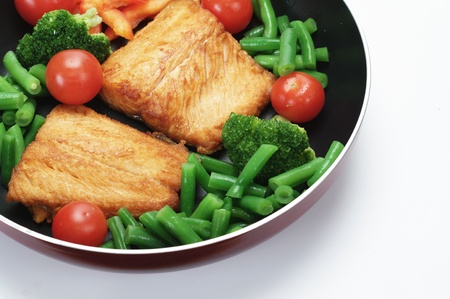 fried salmon with vegetables   on white background