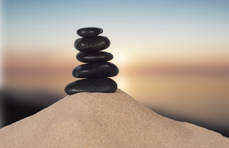 pyramid with five stones on a white backgroundの写真素材