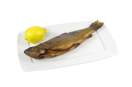 one smoked rainbow trout on white plateの写真素材