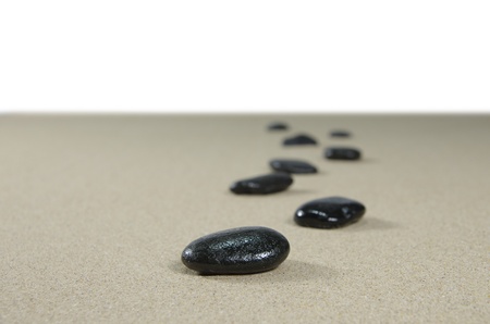 four stones on background of sandの写真素材
