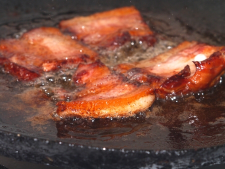 frying on metal pan baconの写真素材