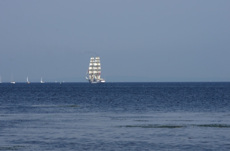 flowing on sea sailing-ship on sky backgroundの写真素材