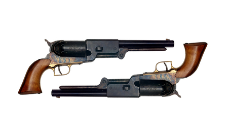 two identical old metal colt revolver on white background