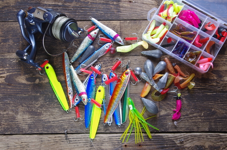 metal angling bait and reel on white backgroundの写真素材