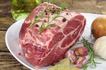 neck with rosemary and basil on white plateの写真素材