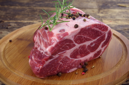 neck with rosemary and basil on chopping boardの写真素材