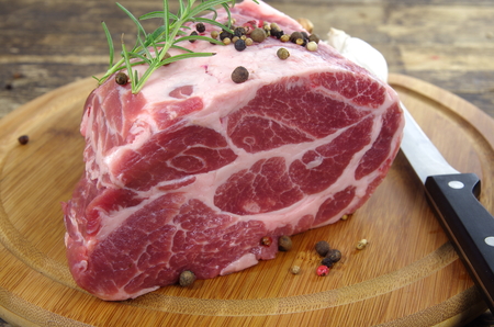 neck with rosemary and basil on chopping boardの写真素材