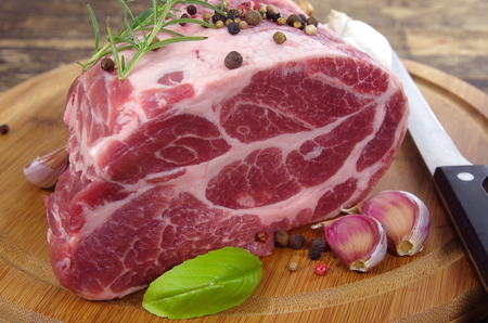 neck with rosemary and basil on chopping boardの写真素材