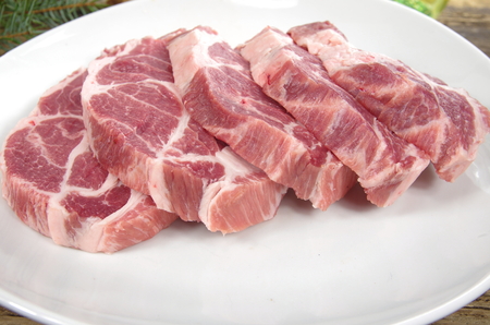 raw chuck steak  on white plateの写真素材