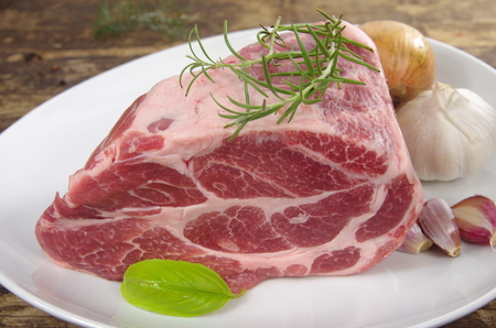 neck with rosemary and basil on white plateの写真素材