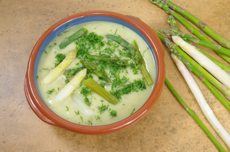 asparagus soup in plate on stone backgroundの写真素材