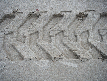 imprint tyre on sandの写真素材