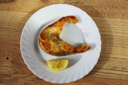 fried salmon with rosemary   on white plate