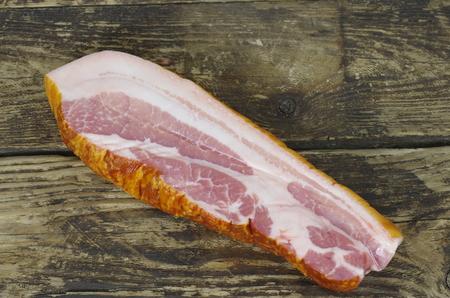 smoked bacon on wooden boardの写真素材