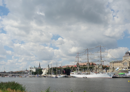 sailing ships near embankment on a sky backgroundの写真素材