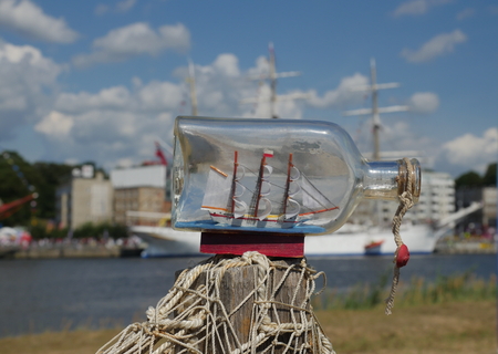 sailcloth ship in closed with cork bottle on harbor backgroundの写真素材