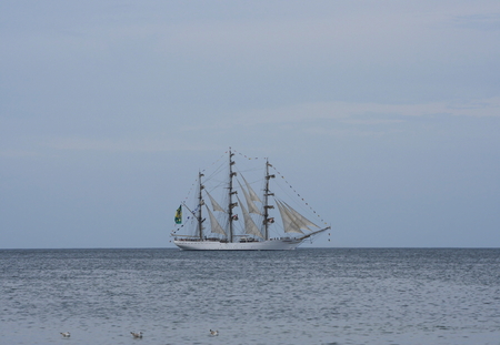 flowing on sea sailing-ship on sky backgroundの写真素材