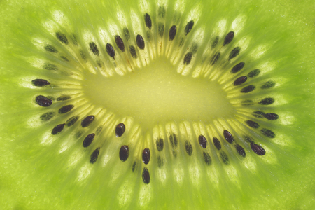 background with cut kiwi fruit macroの写真素材