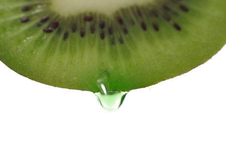 kiwi with dripping clear juice on white backgroundの写真素材