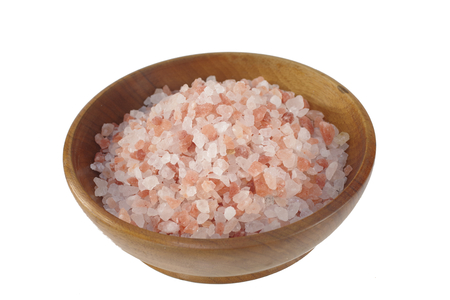 himalayan salt  in wooden dish on white backgroundの写真素材