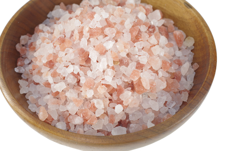 himalayan salt  in wooden dish on white backgroundの写真素材