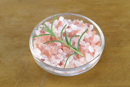 himalayan salt  in glass dish on white backgroundの写真素材