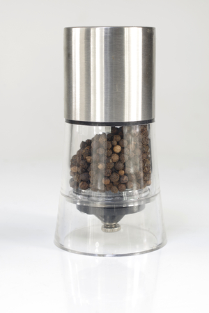 black pepper in a grinder on a bright backgroundの写真素材