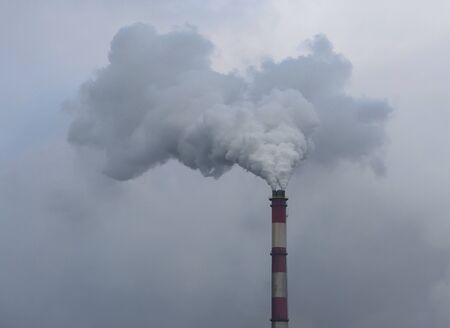 smoky chimney on background of blue sky
