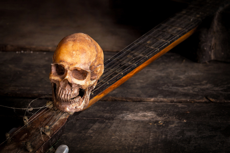 Still life with human skull on guitar backgroundの写真素材