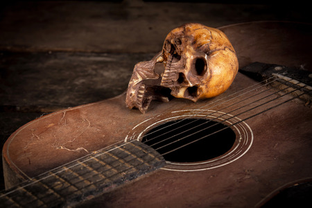 Still life with human skull on guitar backgroundの写真素材