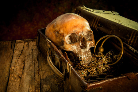 Still life with a human skull with old treasure chest and gold, diamond and jewelryの写真素材