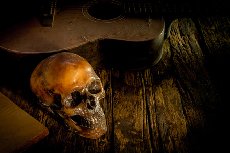 skull and guitar on wood, still lifeの写真素材