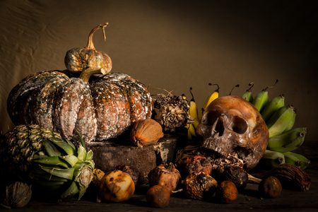 Still Life with human Skull and fruit on old wooden tableの写真素材