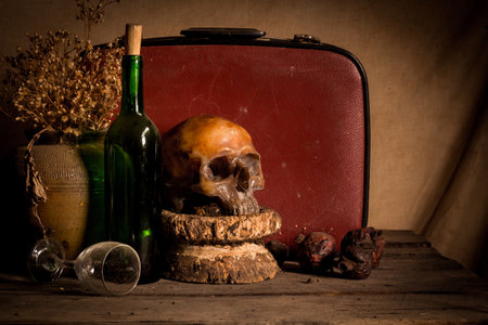 Human skull and flower vase old treasure on wooden table background, Still life conceptの写真素材