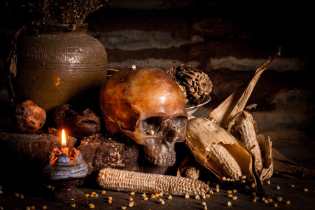 Human skull and candle with on wooden floor and old dirty wall background, and vase flower,and glass,and bottle of wine, still life conceptの写真素材