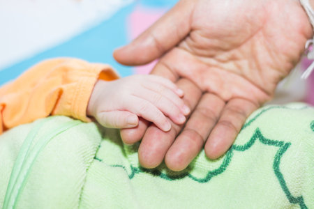 Mother handed her hand to catch her baby.の写真素材