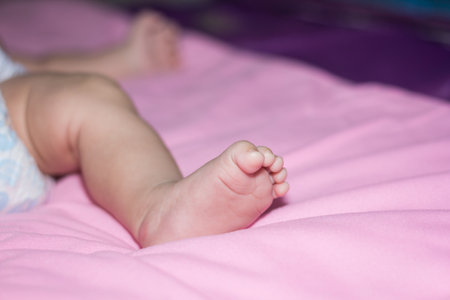 Baby's feet on the mattressの写真素材