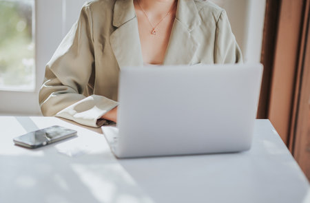 Closeup of businesswoman working with laptop in office. Business concept.の写真素材
